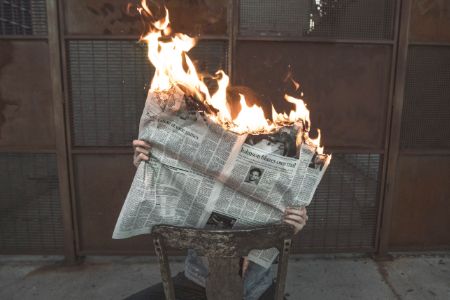 newspaper on fire