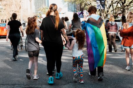 lesbian couple with 2 children marching